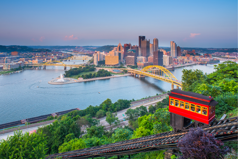 Pittsburgh overlook, incline car, rivers and skyscrapers in background, sunset glow, editorial travel photo, no people.