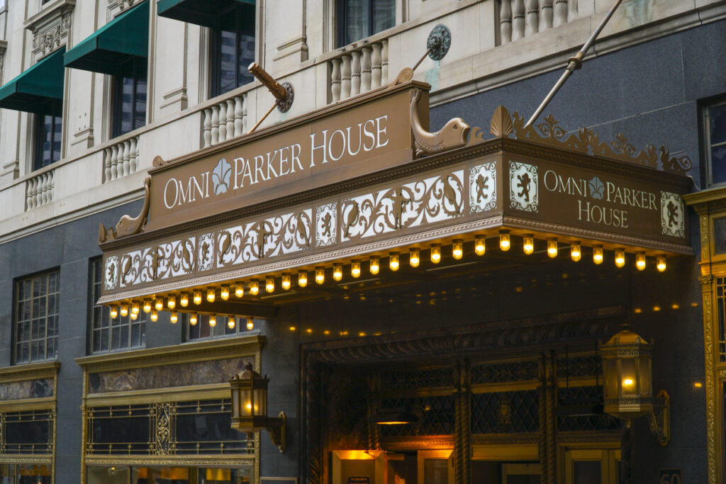 Marquee of Omni Parker House hotel with decorative facade and illuminated lights.