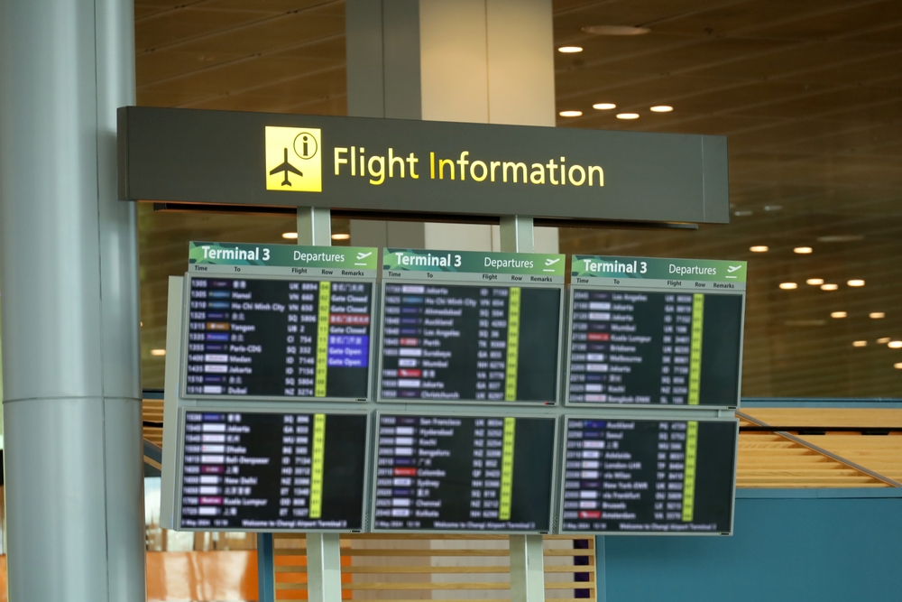 "Airport flight information board displaying departure details for Terminal 3 with multiple flights listed."